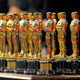 a line up of 22 oscar statues.